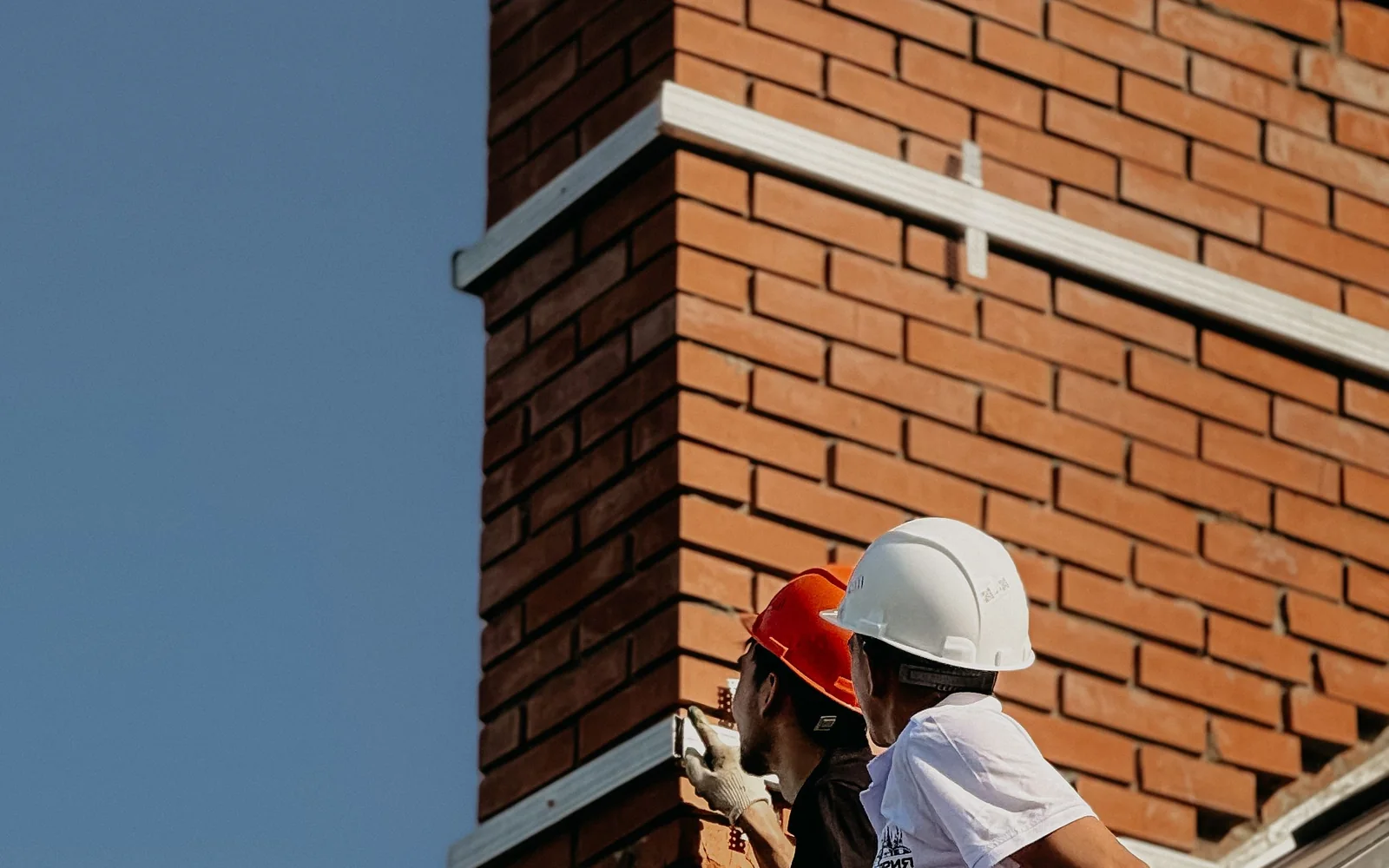 Roof maintenance inspection at chimney flashing